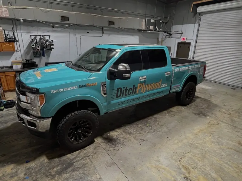 Ditch Plywood turquoise branded pickup truck