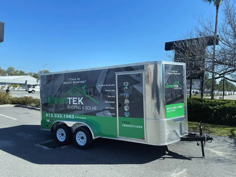 GreenTEK Roofing and Solar enclosed trailer with green and charcoal graphics