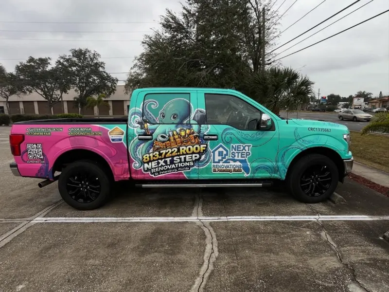 Next Step Renovations pickup with turquoise and pink octopus graphics
