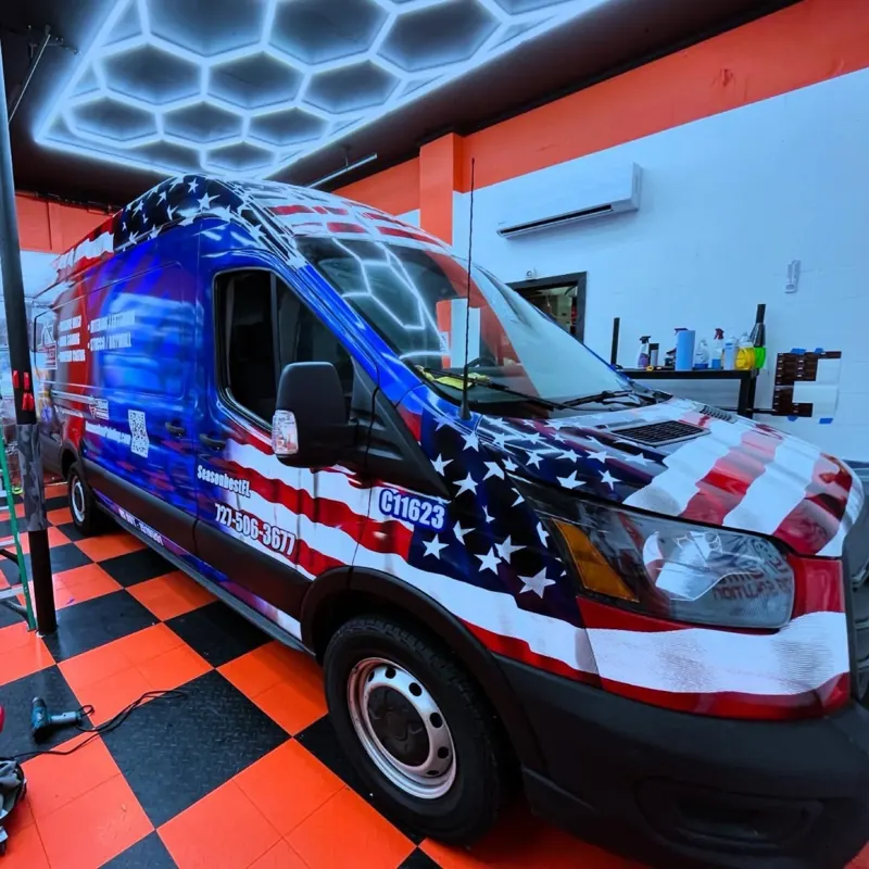 Commercial cargo van wrapped in patriotic red white and blue graphics