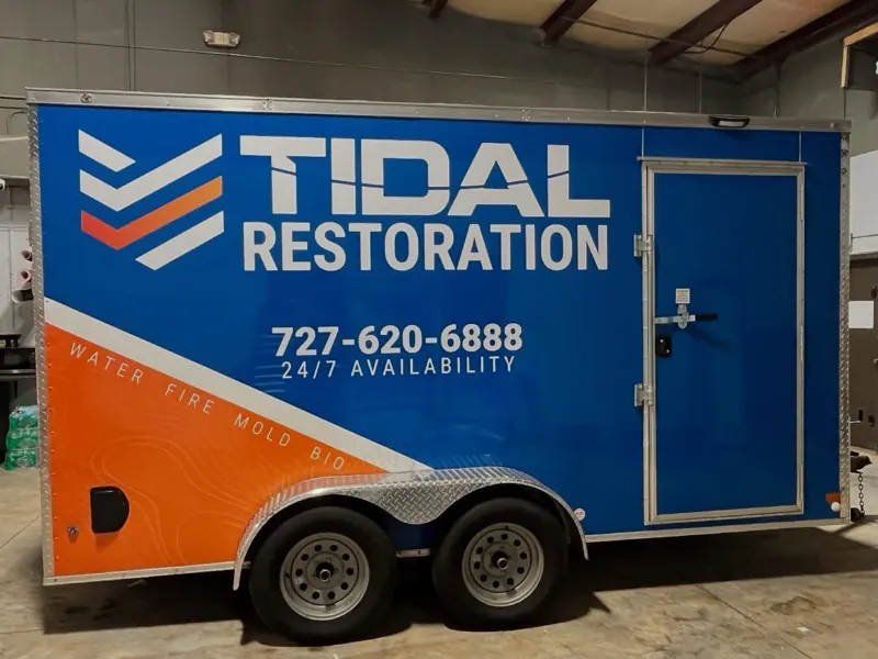 Blue and orange Tidal Restoration enclosed trailer wrap